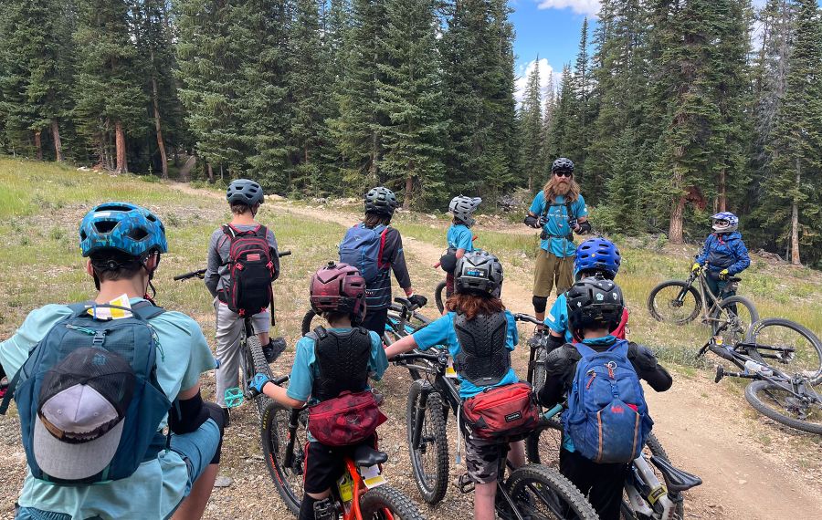 downhill camp preparation with riders listening a coach before beginning the downhill camp 