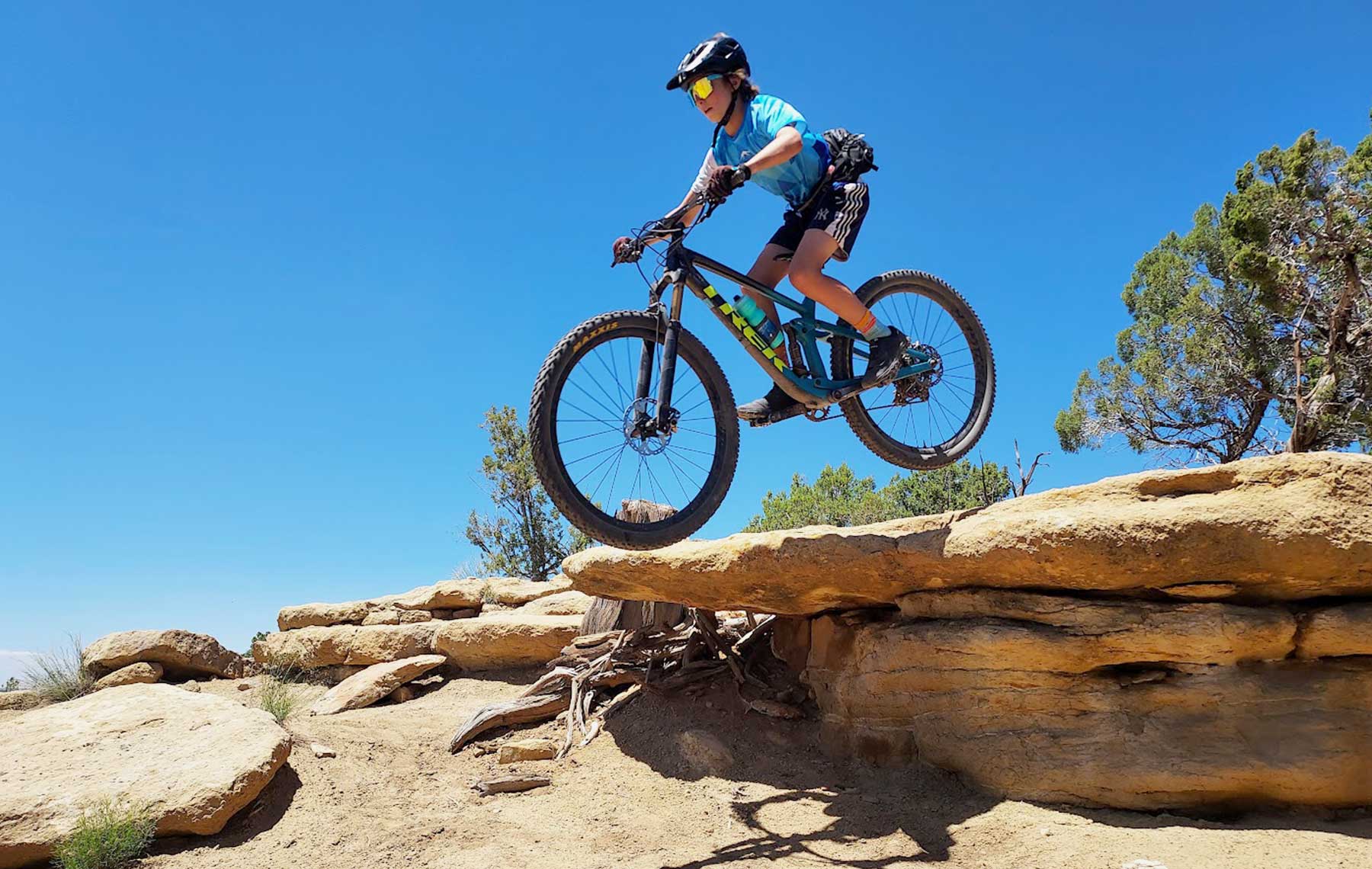 mountain biker jumps a small rock drop off